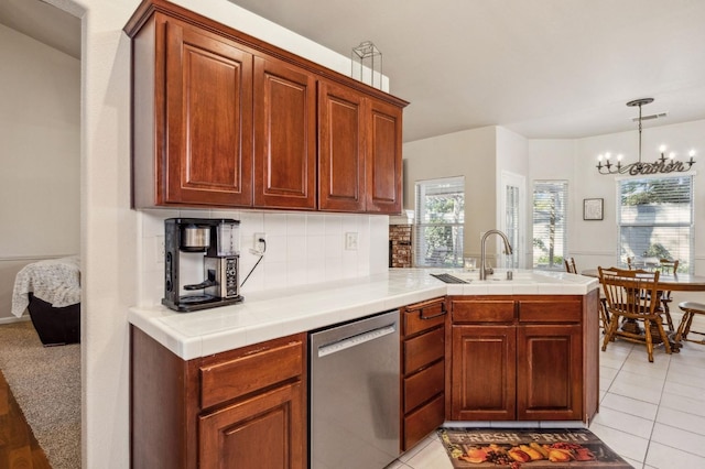 kitchen featuring light tile patterned floors, kitchen peninsula, tasteful backsplash, dishwasher, and sink