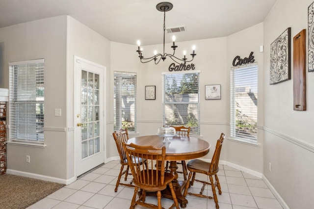 dining room featuring light tile patterned flooring and an inviting chandelier