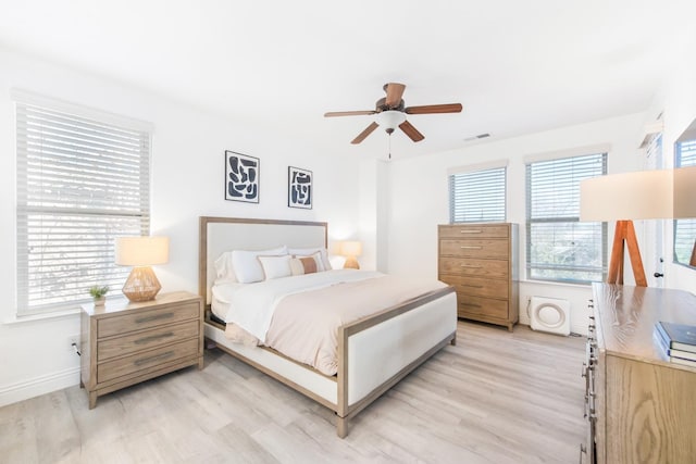 bedroom with ceiling fan and light hardwood / wood-style floors