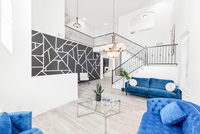 living room with wood-type flooring and an inviting chandelier