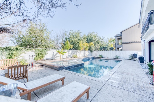 view of swimming pool with an in ground hot tub and a patio