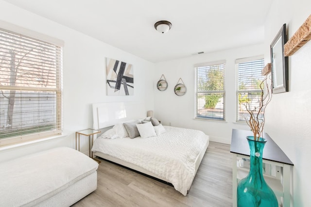 bedroom with light hardwood / wood-style floors