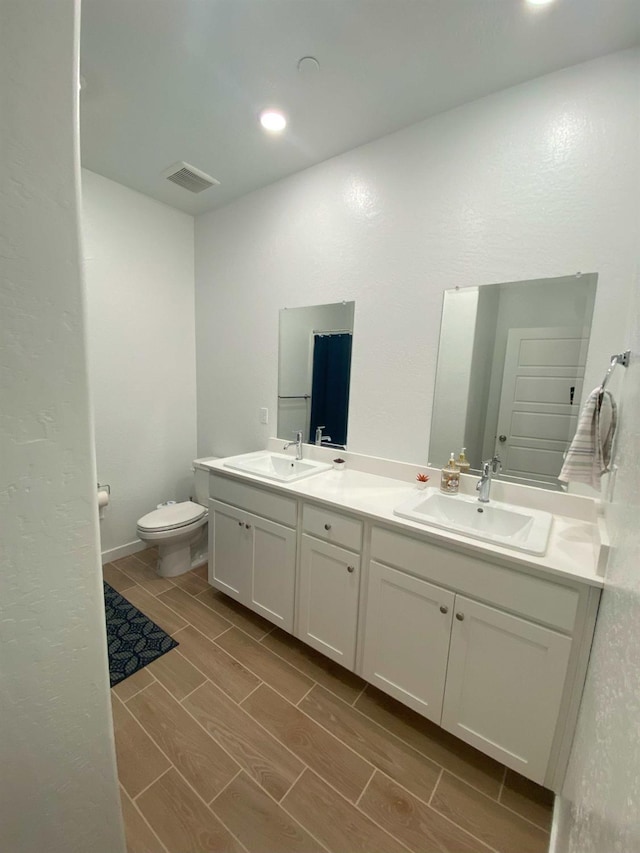 bathroom with toilet and vanity