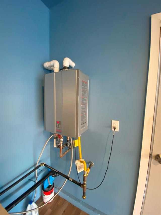 utility room featuring water heater