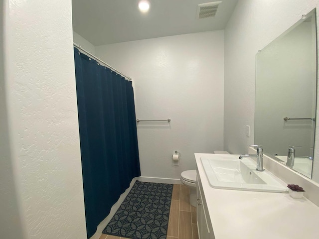 bathroom with toilet and vanity