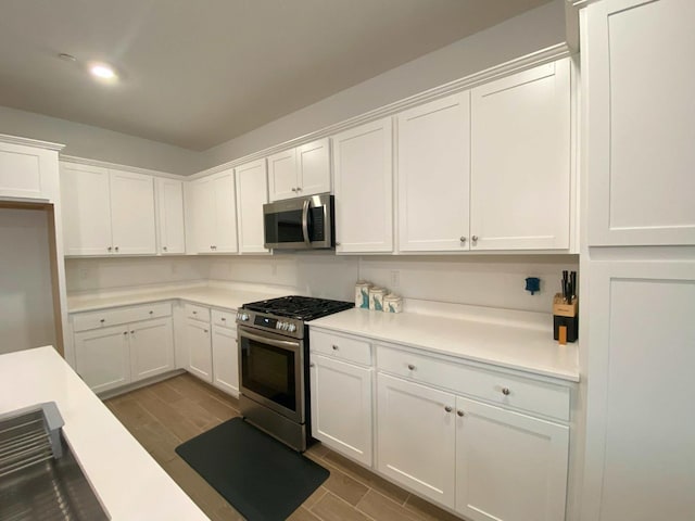 kitchen featuring appliances with stainless steel finishes and white cabinets