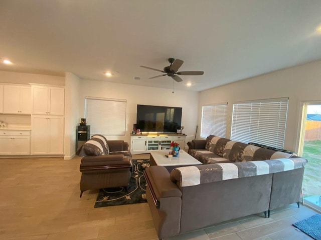 living room featuring ceiling fan and light wood-type flooring