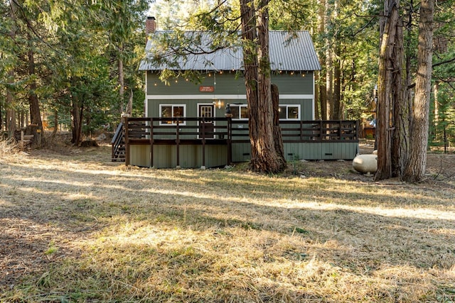 exterior space featuring a yard and a wooden deck