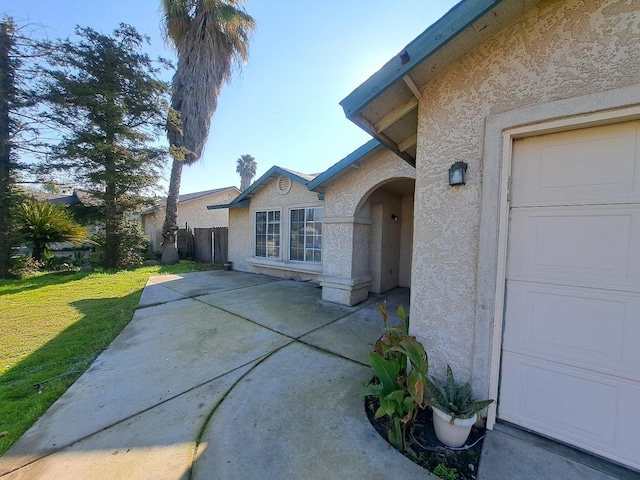 exterior space with a yard and a garage