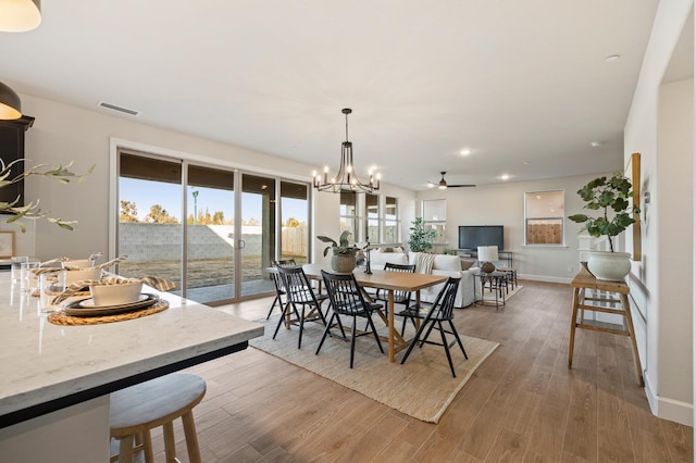 dining area with hardwood / wood-style floors and a chandelier