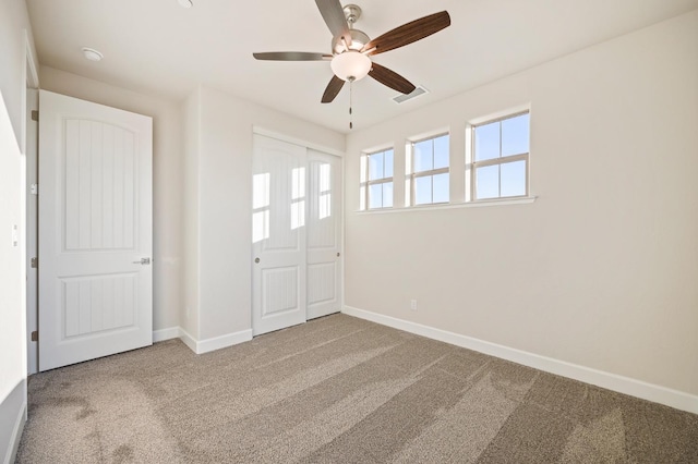 carpeted empty room with ceiling fan