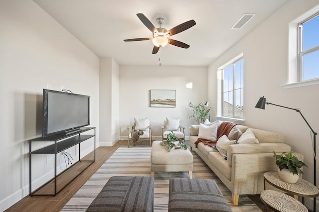 living room featuring ceiling fan and hardwood / wood-style flooring