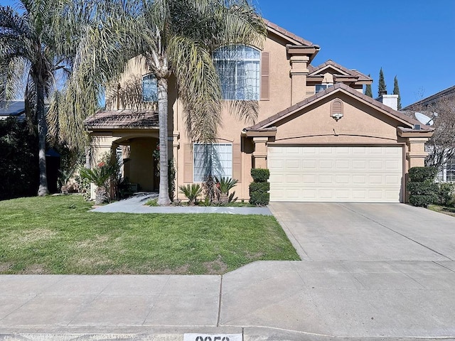 view of front facade featuring a garage, concrete driveway, a front yard, and stucco siding