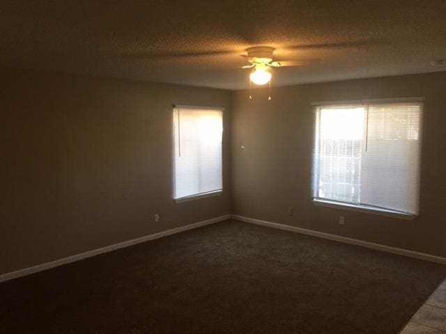 unfurnished room featuring a textured ceiling and ceiling fan