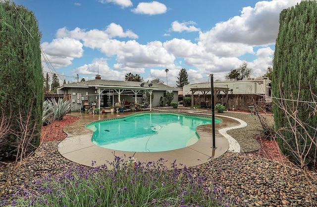 view of swimming pool featuring a patio, a fenced backyard, and a fenced in pool