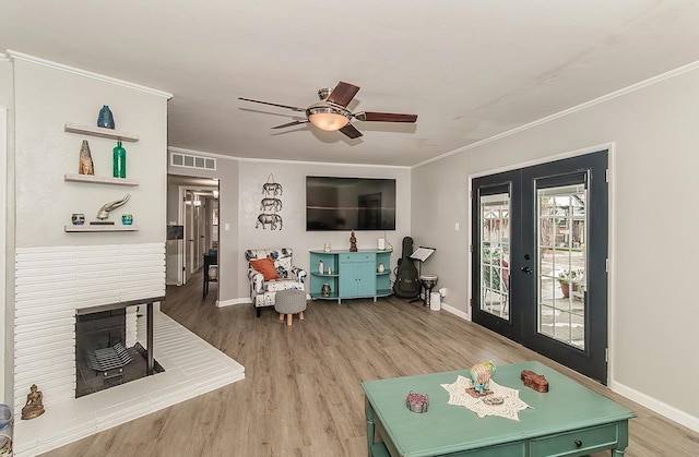 living room featuring ornamental molding, french doors, and visible vents