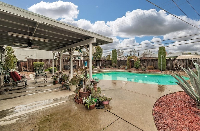 view of swimming pool with a patio, a fenced backyard, a fenced in pool, and a ceiling fan