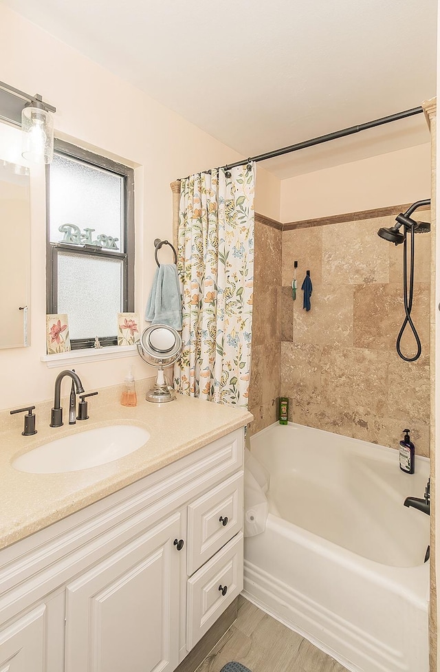 bathroom featuring shower / bath combo with shower curtain and vanity