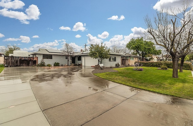 single story home featuring a garage, solar panels, concrete driveway, fence, and a front lawn