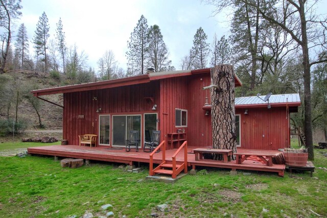 back of house with a wooden deck and a yard