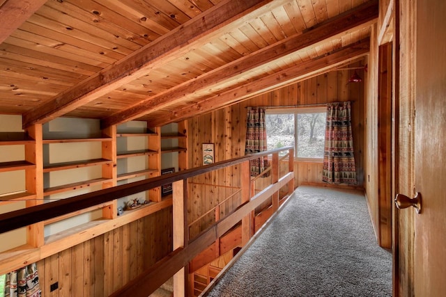 interior space featuring carpet floors, vaulted ceiling with beams, wood ceiling, and wood walls