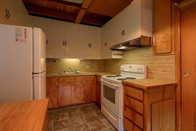 kitchen with wood counters, decorative backsplash, sink, and white appliances