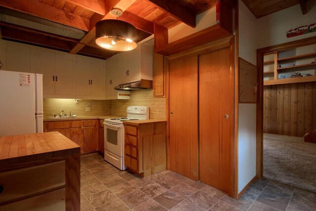 kitchen featuring carpet floors, sink, and white appliances