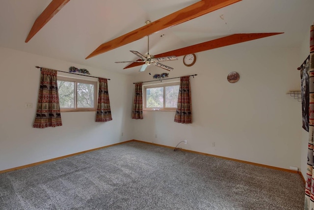 spare room featuring ceiling fan, a wealth of natural light, carpet, and vaulted ceiling with beams