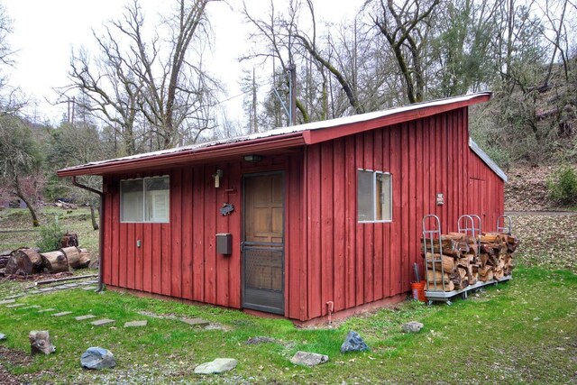 view of outbuilding featuring a yard