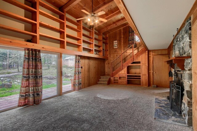 unfurnished living room featuring wood ceiling, wooden walls, high vaulted ceiling, carpet flooring, and beamed ceiling