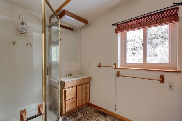 bathroom featuring walk in shower and vanity