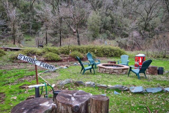 view of yard with an outdoor fire pit