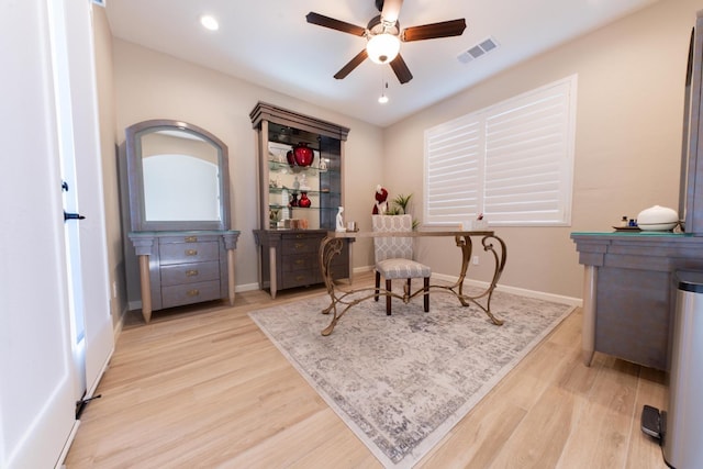 office with ceiling fan and light hardwood / wood-style flooring