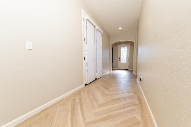 doorway with light parquet flooring