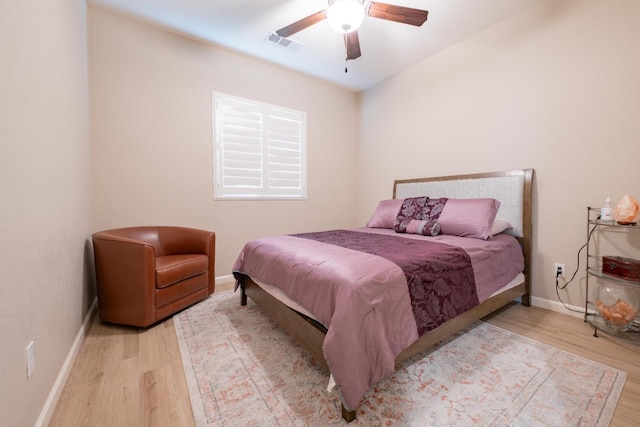 bedroom with ceiling fan and light hardwood / wood-style floors