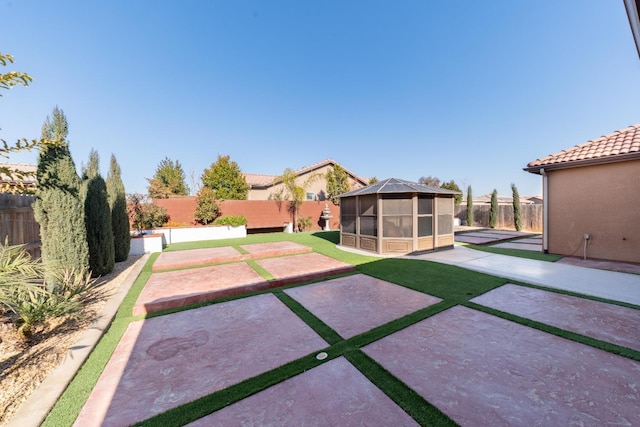 view of yard with a sunroom and a patio