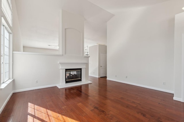 unfurnished living room with ceiling fan and dark wood-type flooring