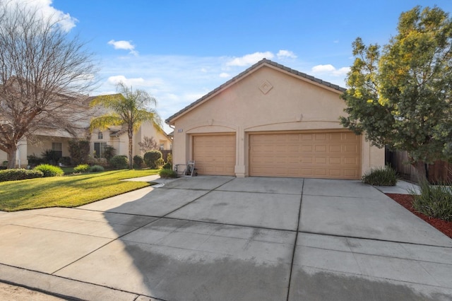 view of front of property with a garage and a front lawn