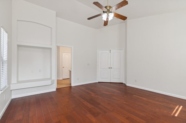 unfurnished bedroom with ceiling fan and dark hardwood / wood-style floors