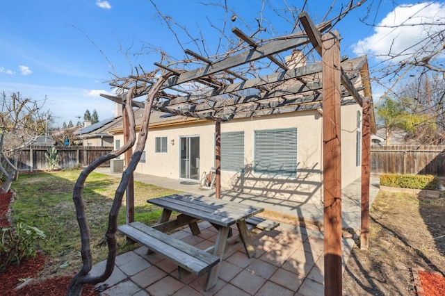 rear view of property with a pergola, a yard, and a patio