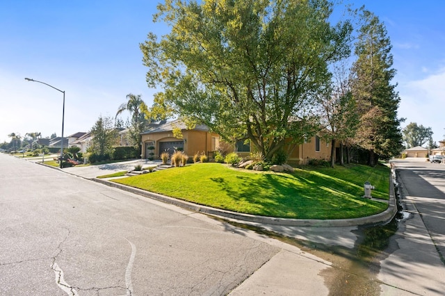 ranch-style home featuring a front lawn and a garage