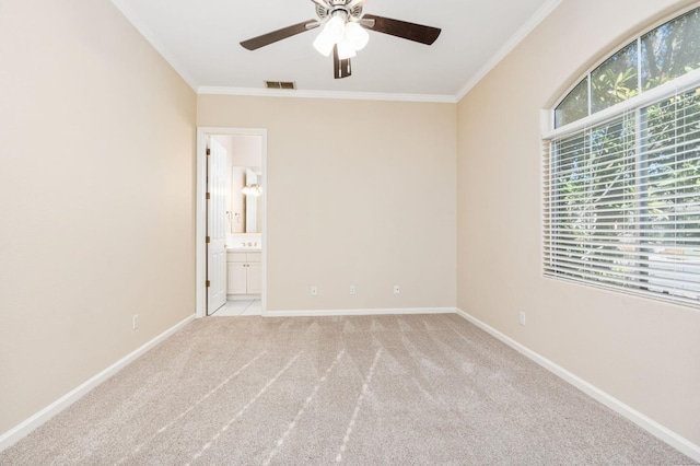 carpeted spare room featuring ceiling fan and crown molding