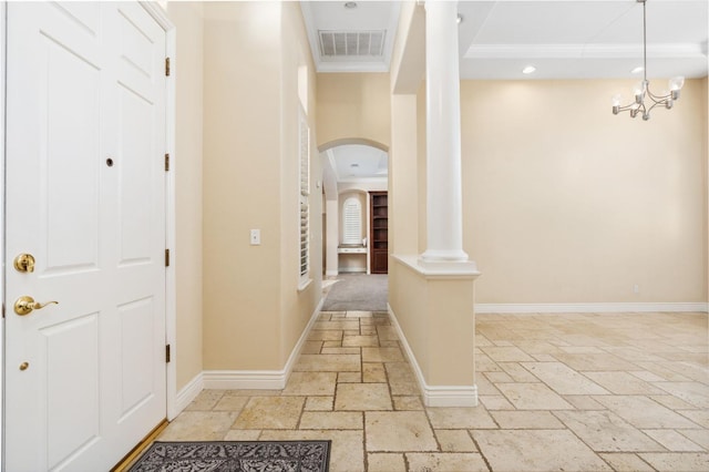 corridor with decorative columns and ornamental molding