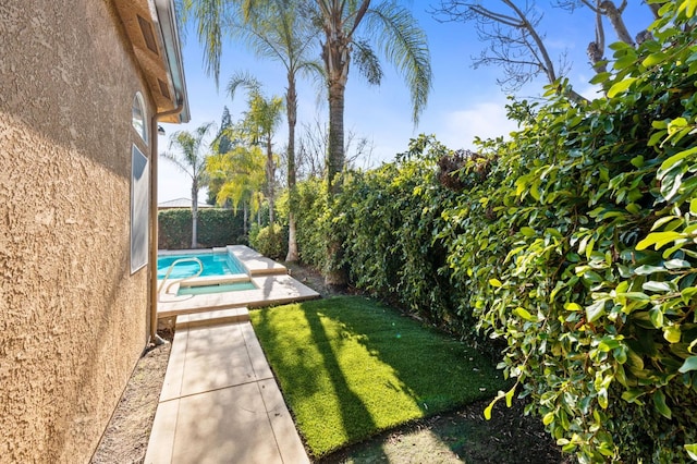 view of yard with a fenced in pool