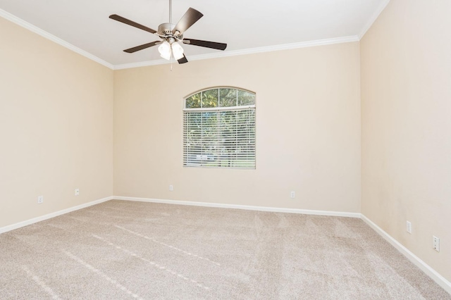 carpeted spare room featuring ceiling fan and crown molding