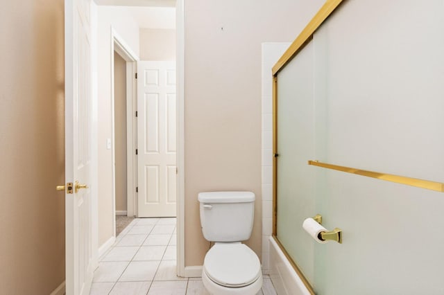 bathroom with toilet, tile patterned flooring, and combined bath / shower with glass door