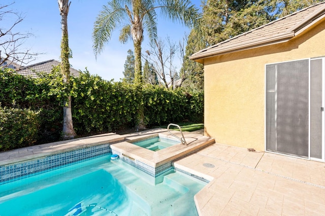 view of swimming pool with an in ground hot tub