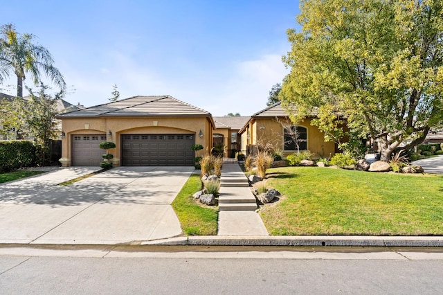 view of front of home with a front lawn and a garage