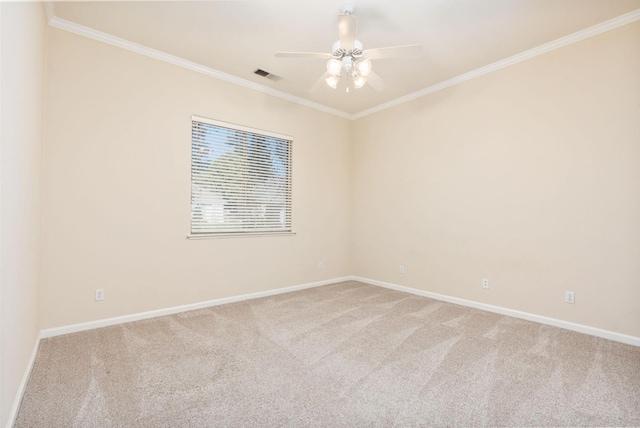 spare room with carpet floors, ceiling fan, and crown molding