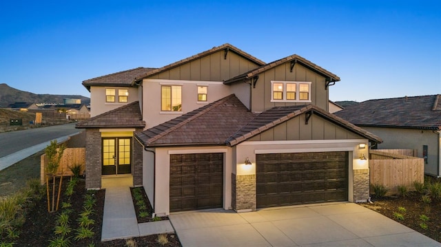 view of front facade featuring a mountain view and a garage